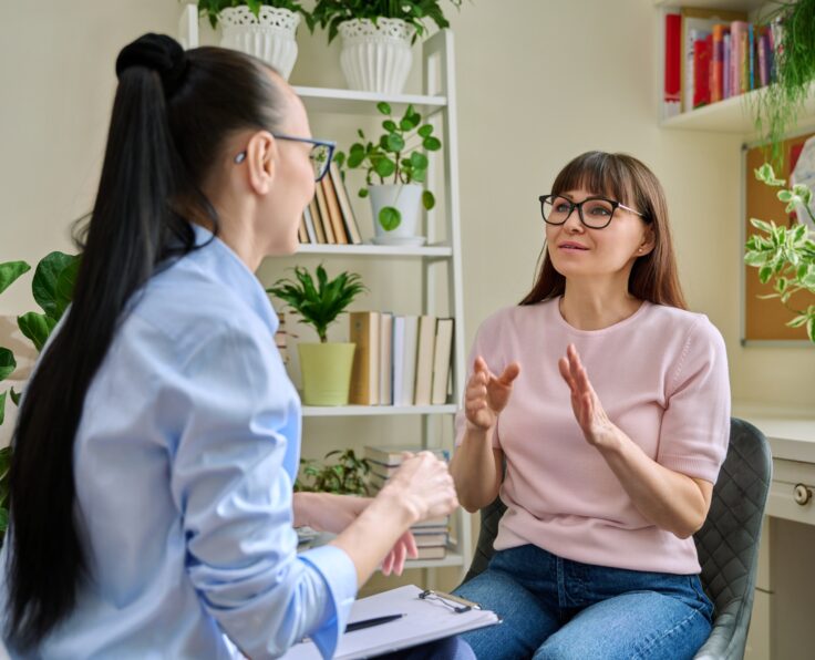 Mental therapy, session of smiling middle-aged female patient with psychological counselor